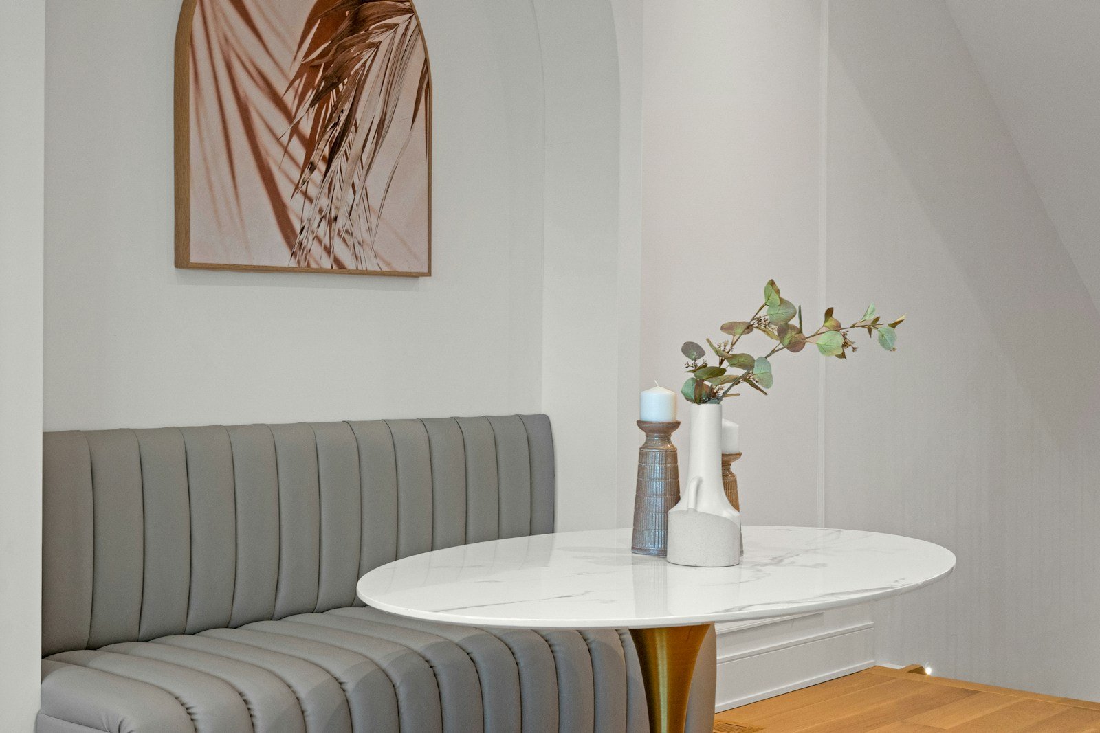 Grey banquette seating around a marble dining table