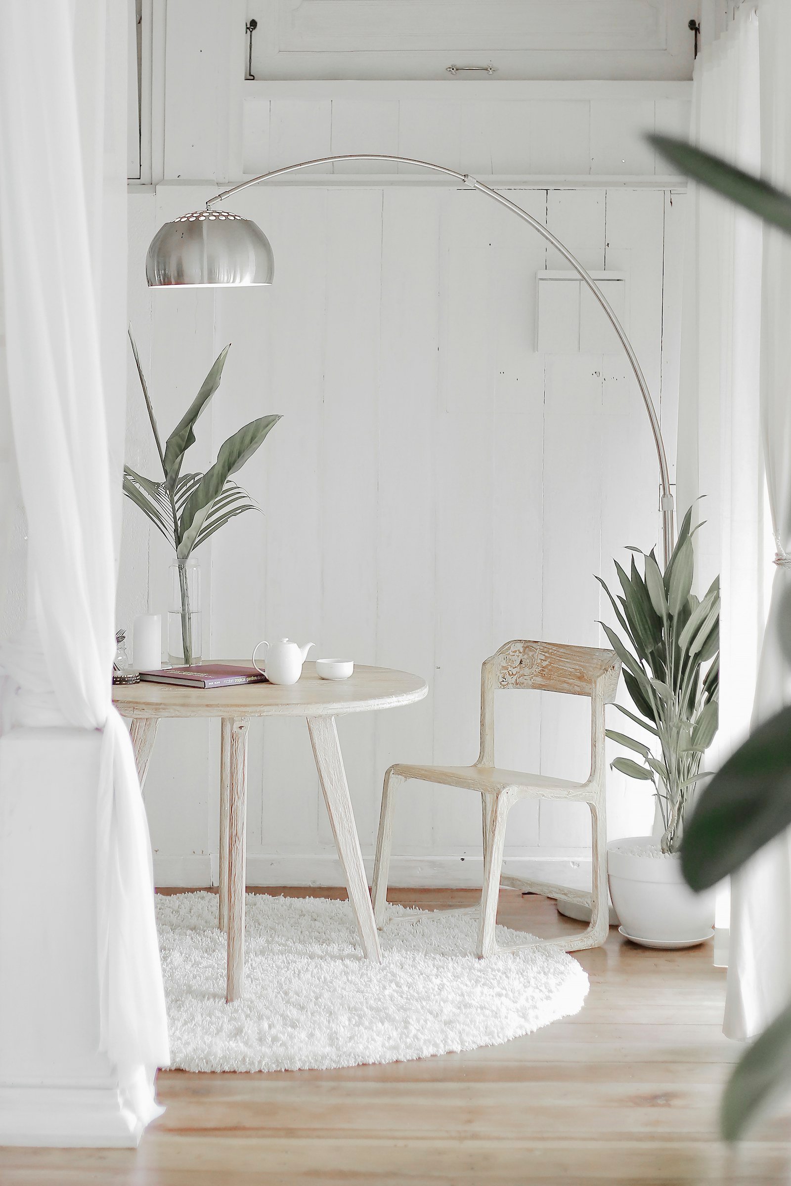 bedroom reading corner with armchair and floor lamp