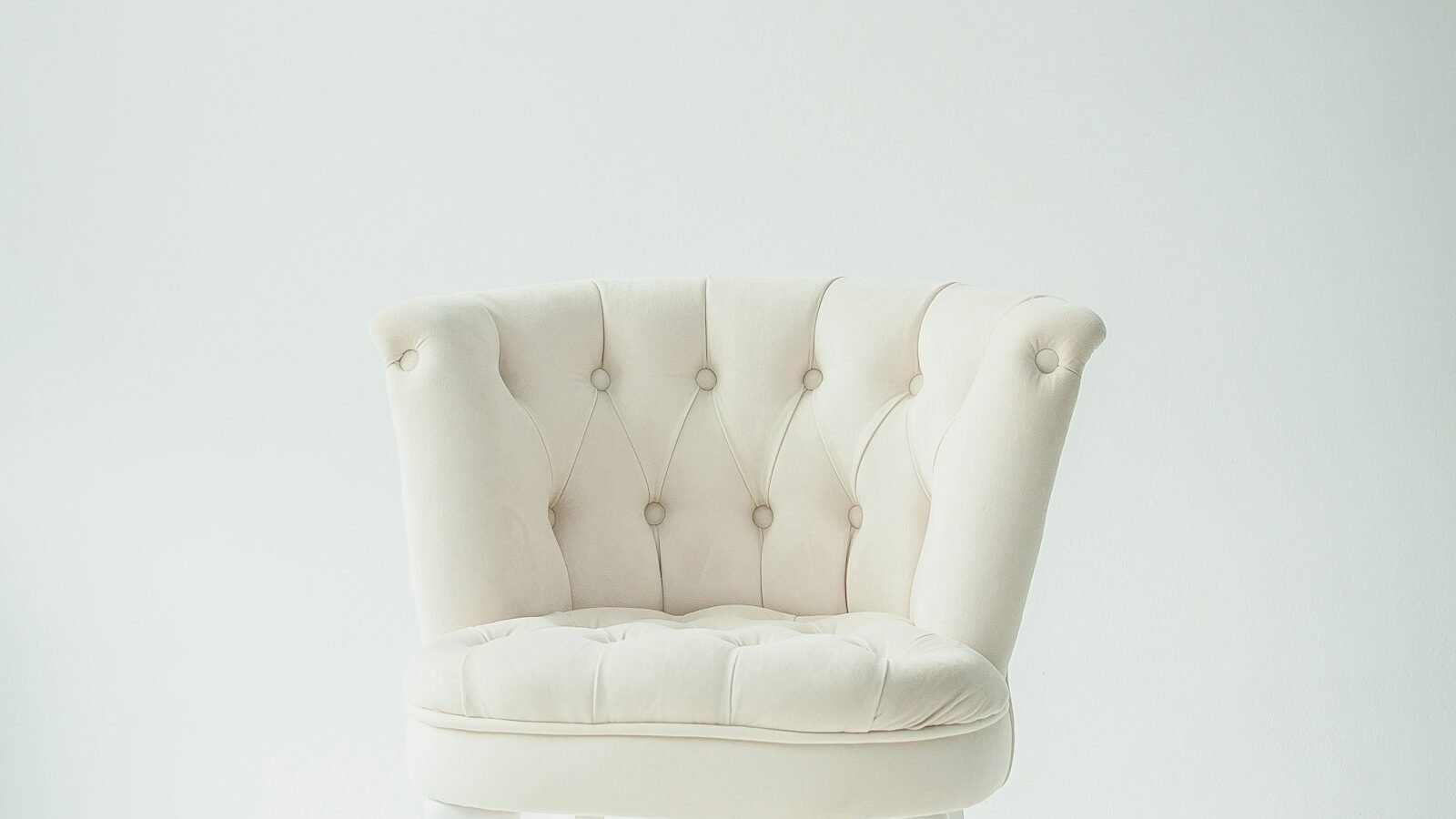 upholstered chair bed beside a reading lamp