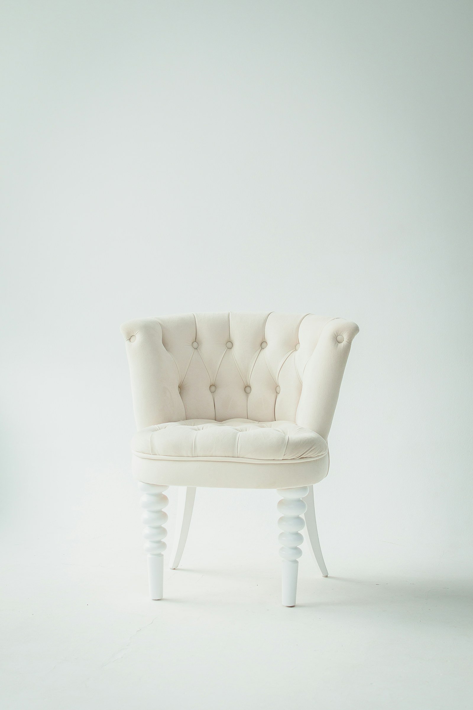 upholstered chair bed beside a reading lamp