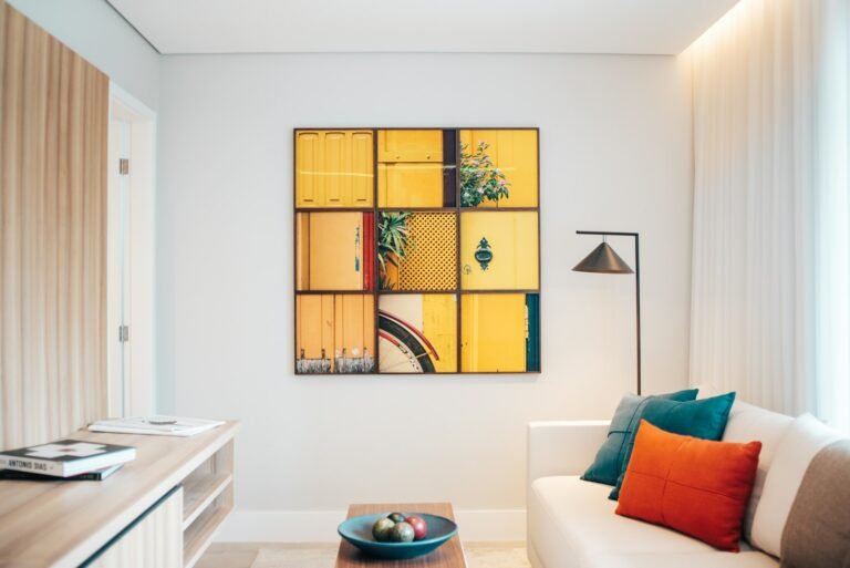 White sofa styled with teal and orange cushions in a bright living room