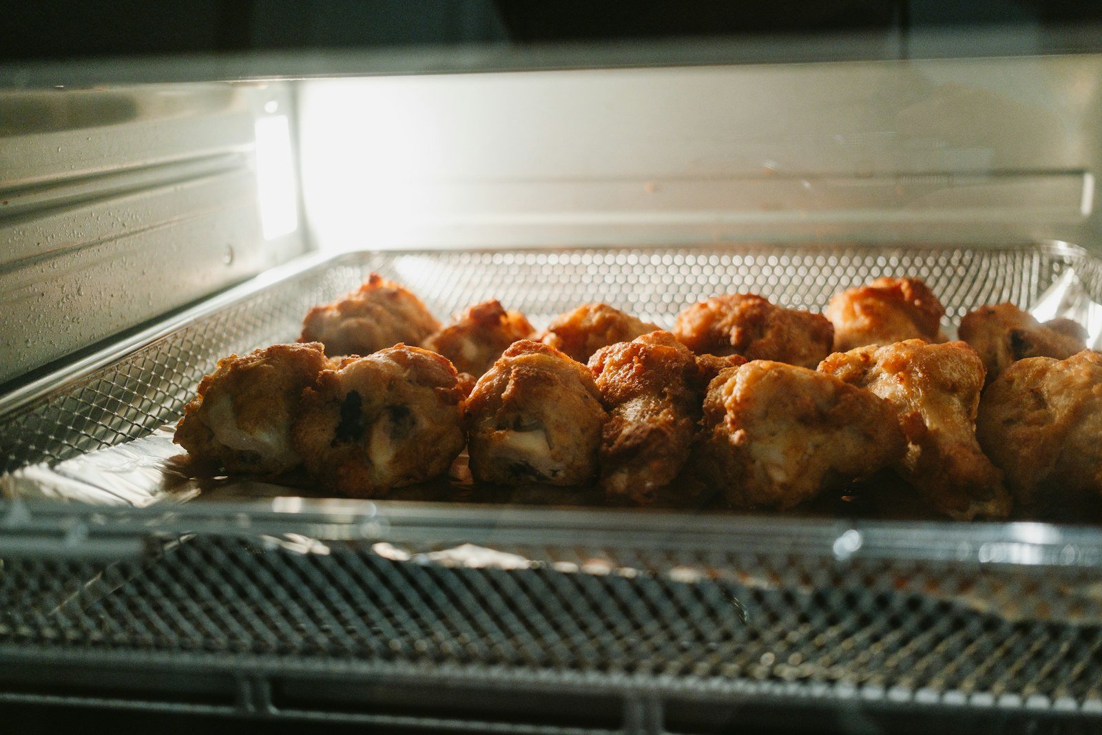 Food cooking on a tray inside a countertop oven