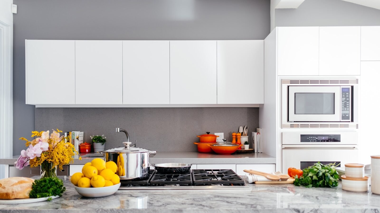 Stainless steel cookware arranged on a modern kitchen hob