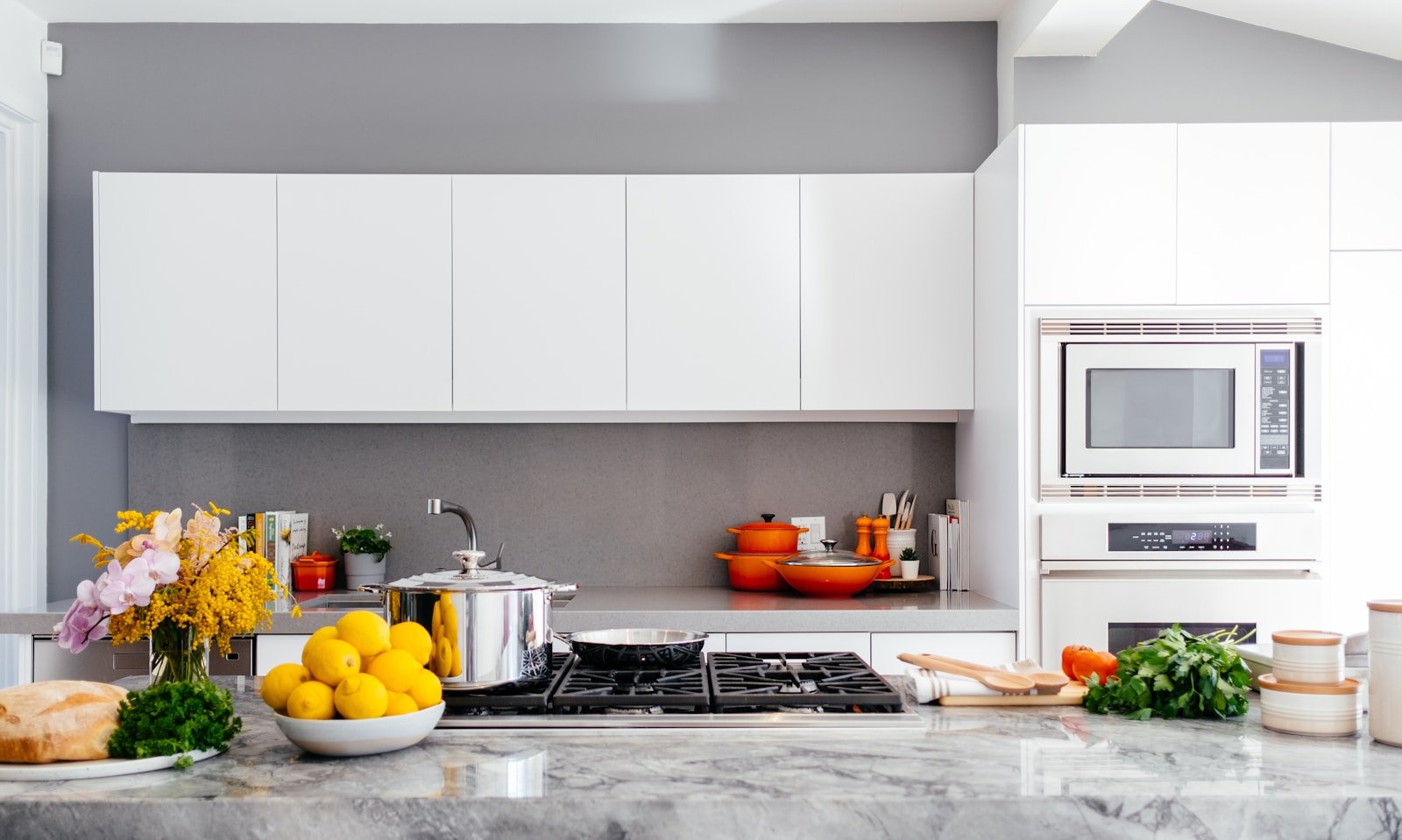 Stainless steel cookware arranged on a modern kitchen hob