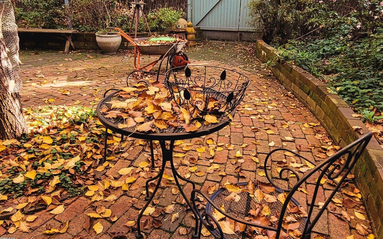 teak garden sofa arranged in a practical UK setting
