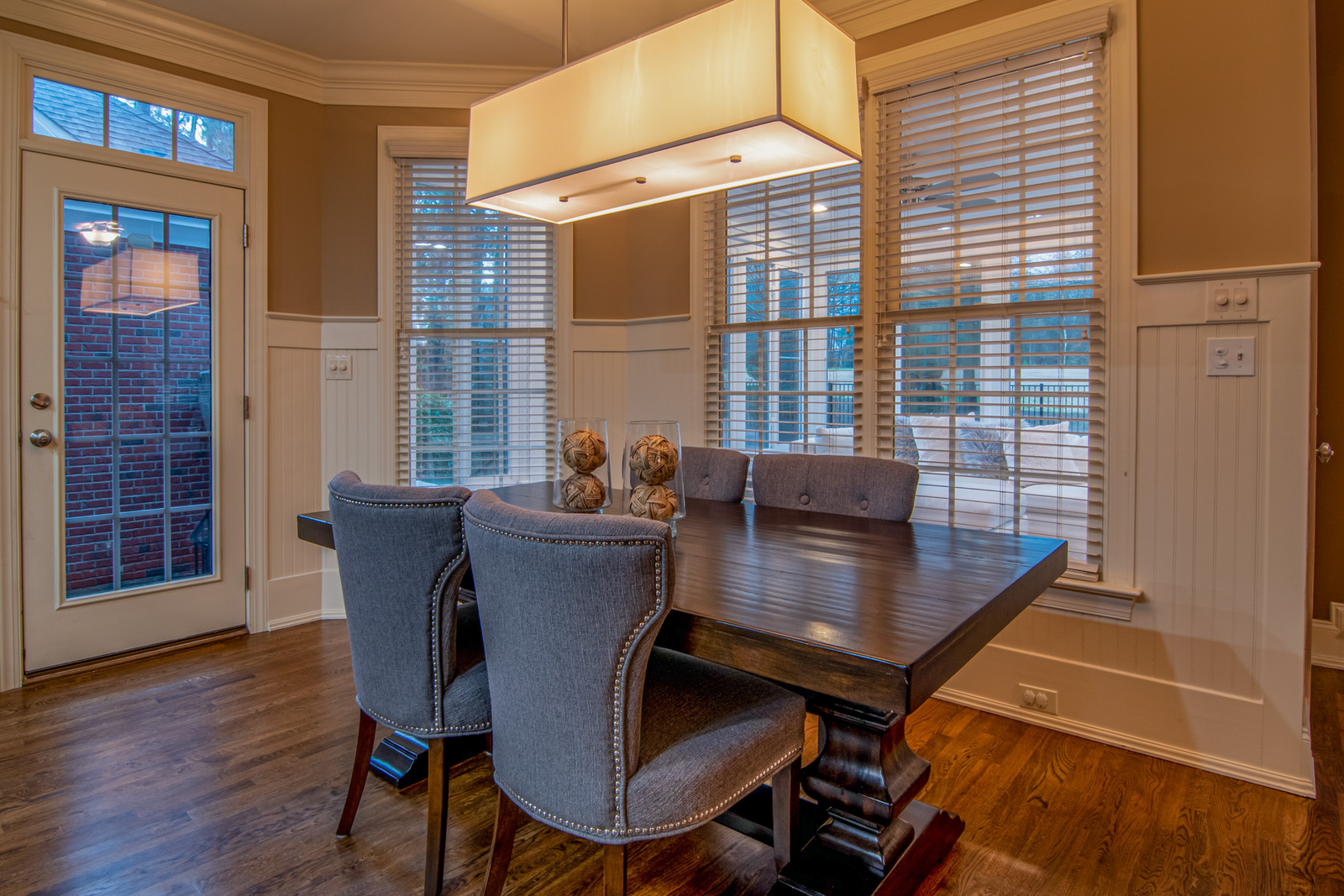 Dining room with large windows illustrating bay window shade planning