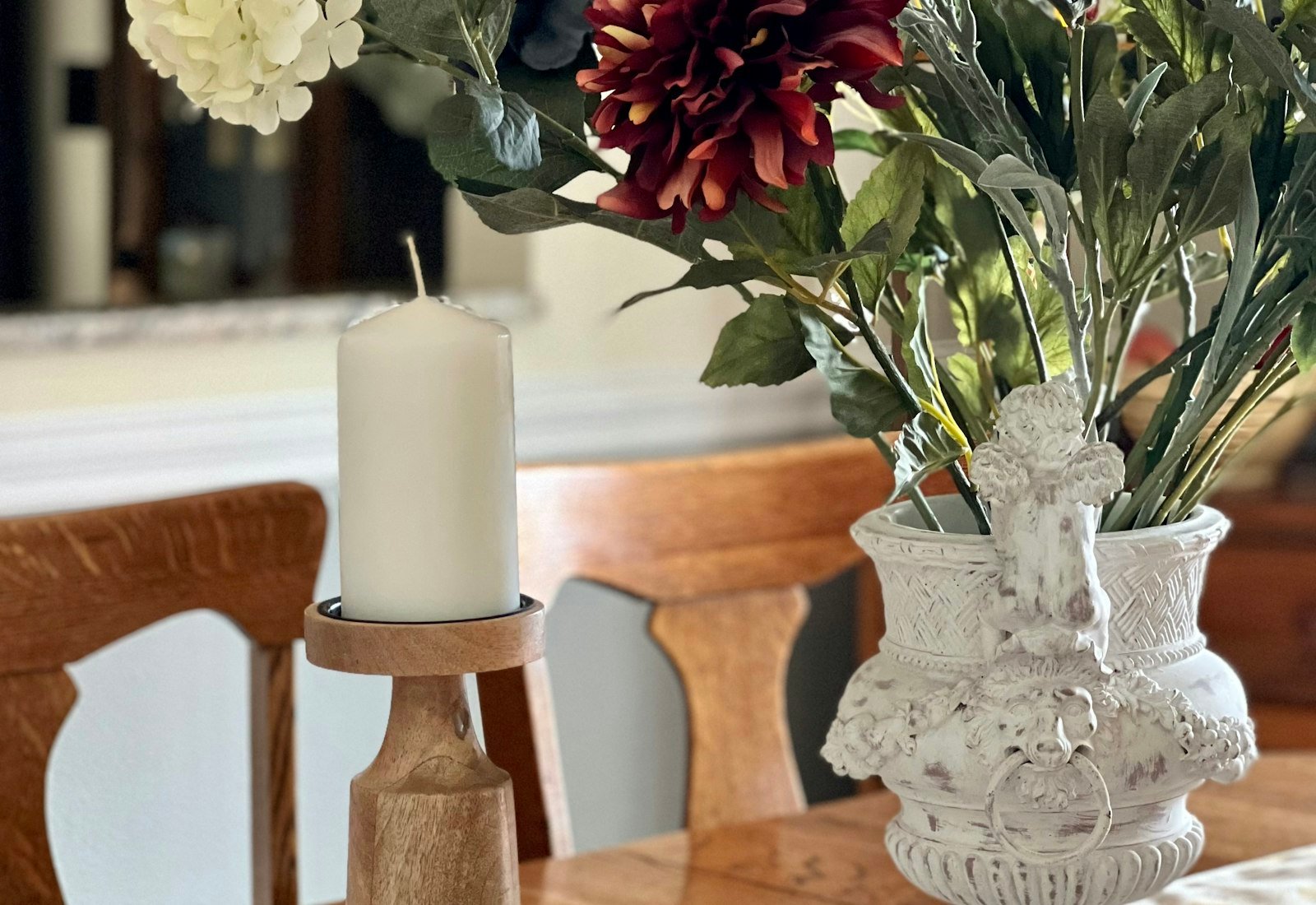 Solid oak dining table with vase and candle in a UK home interior