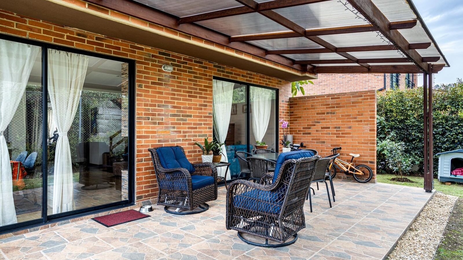 Outdoor garden furniture on a brick patio ready for weather protection