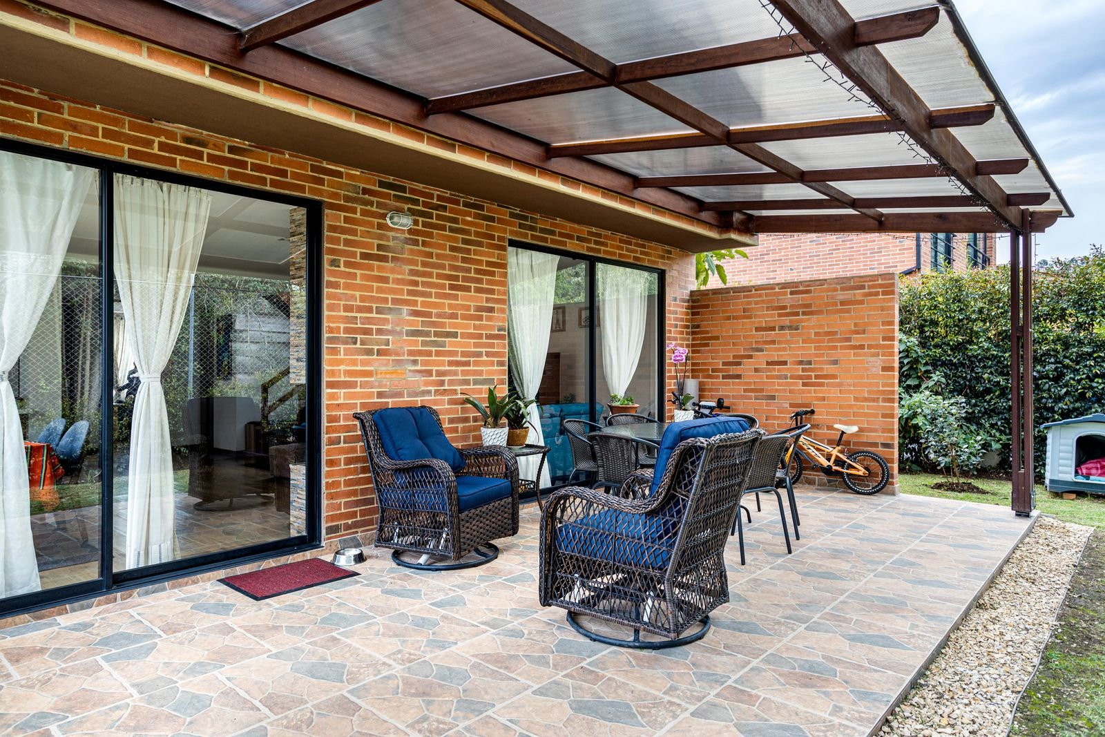 Outdoor garden furniture on a brick patio ready for weather protection