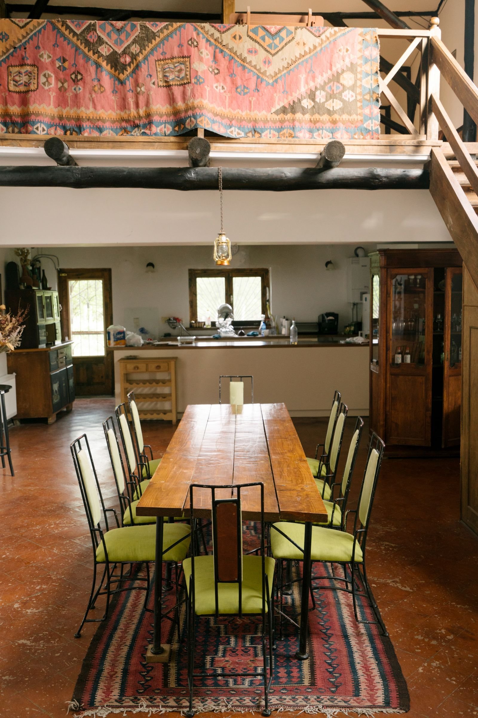 Patterned rugs and a long runner in a warm dining interior