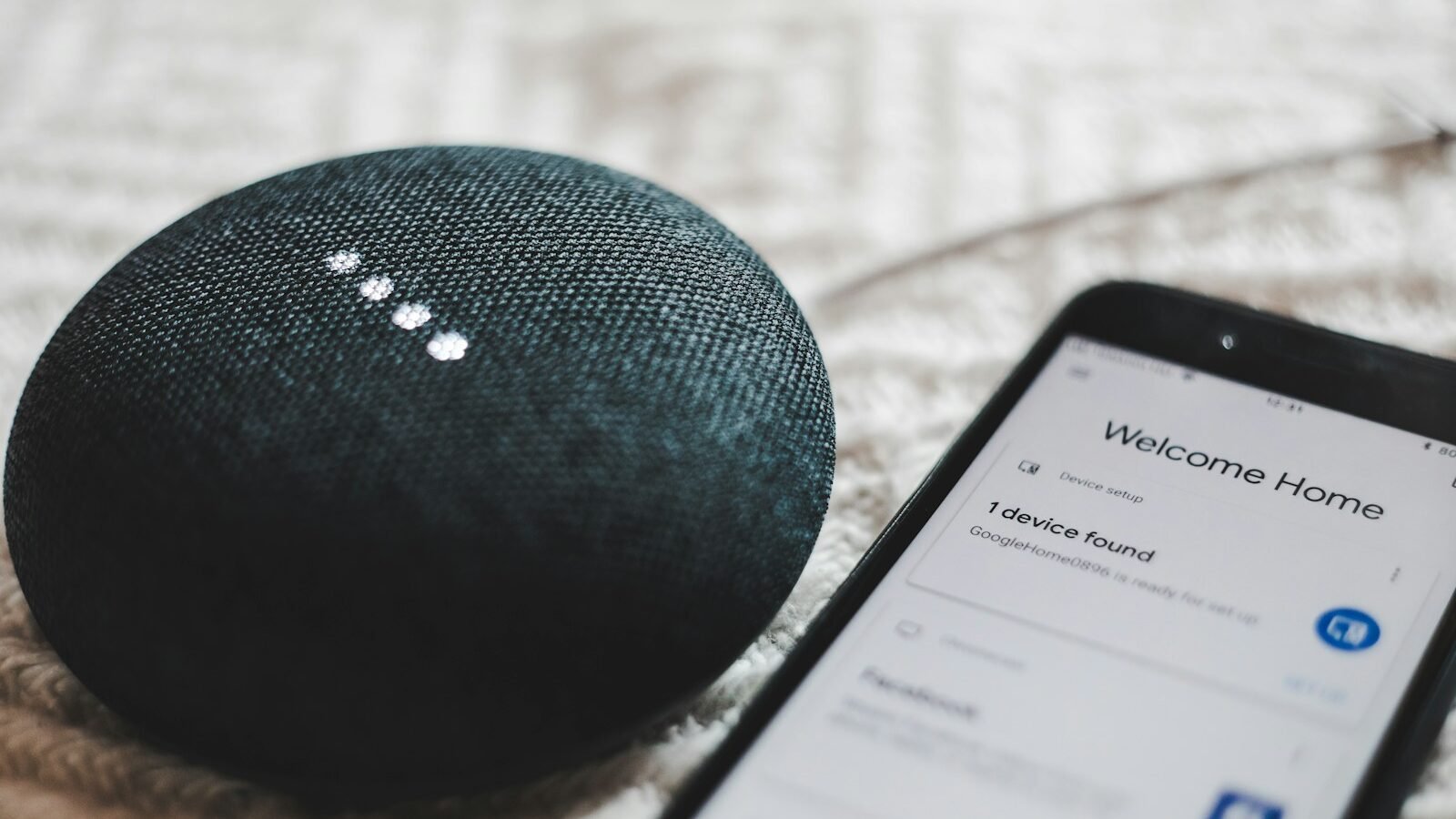 Smart speaker and phone showing a connected smart home setup