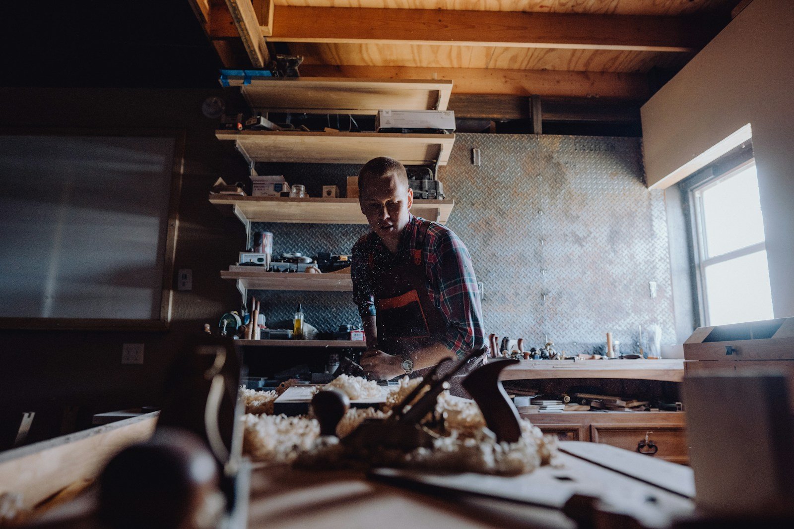 Woodworker using hand tools in a workshop