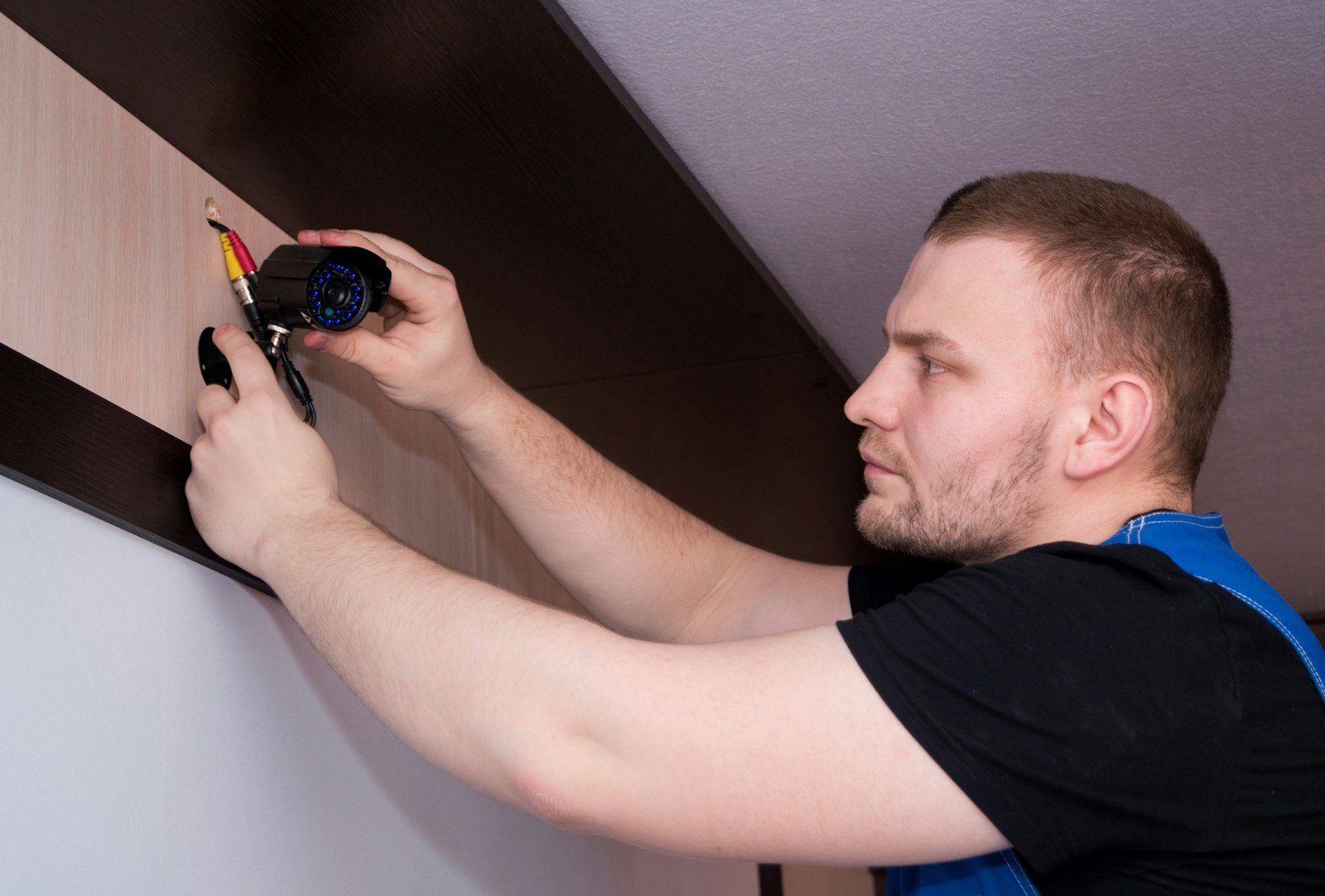 Person using a screwdriver to inspect a wall during home maintenance