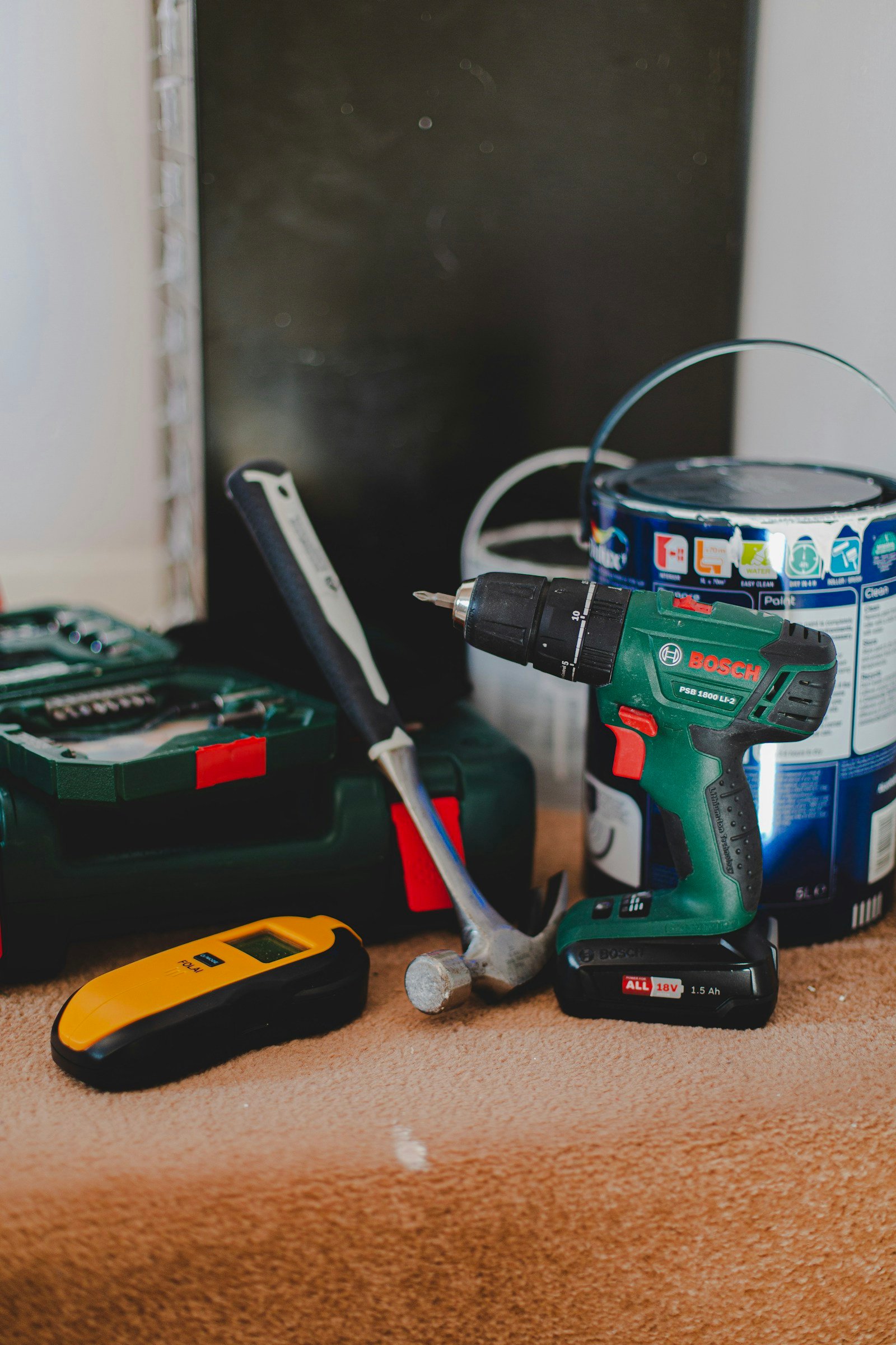 Cordless drill, hammer and stud finder ready for home maintenance