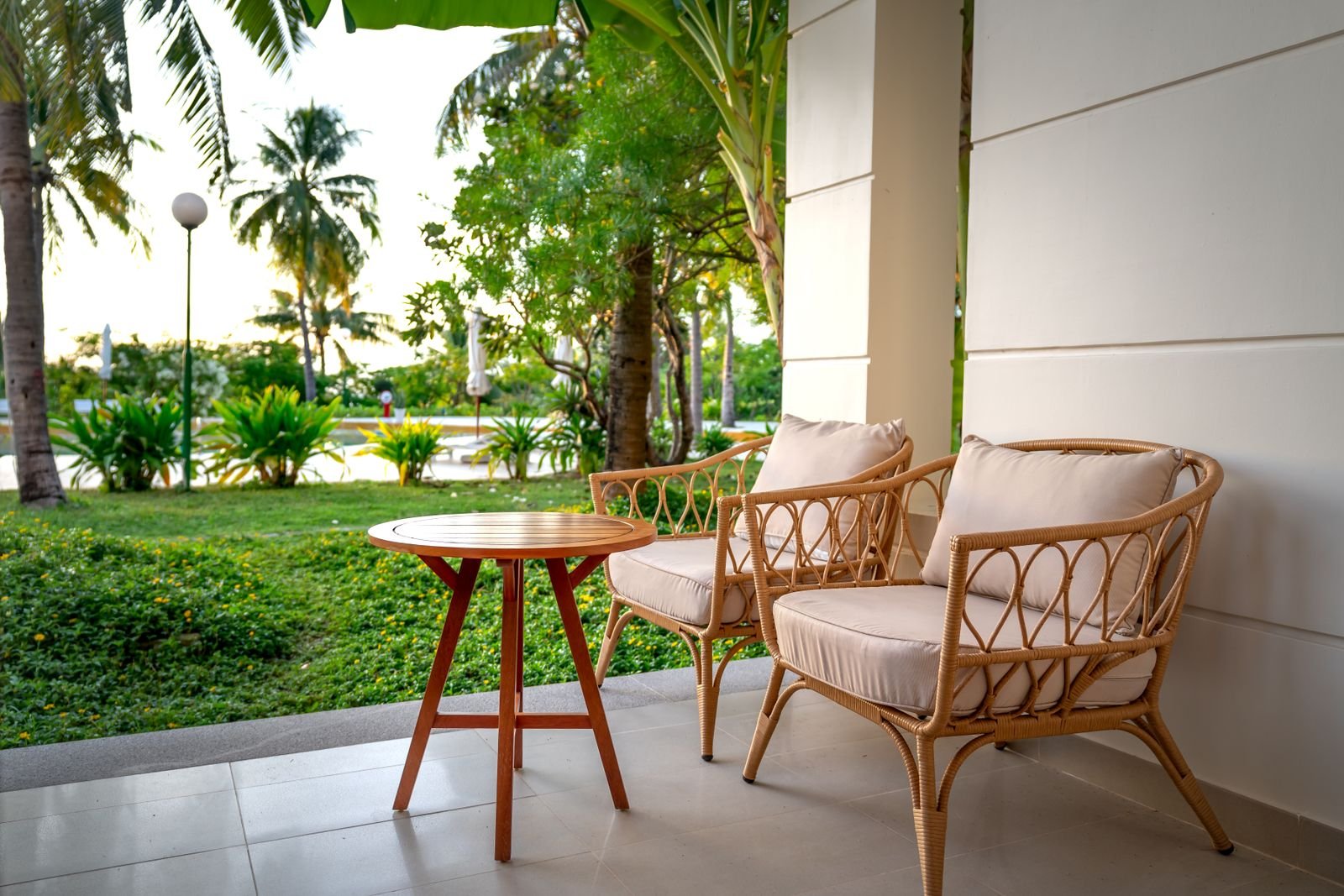 Rattan chairs on a patio illustrating cover fit and weather protection