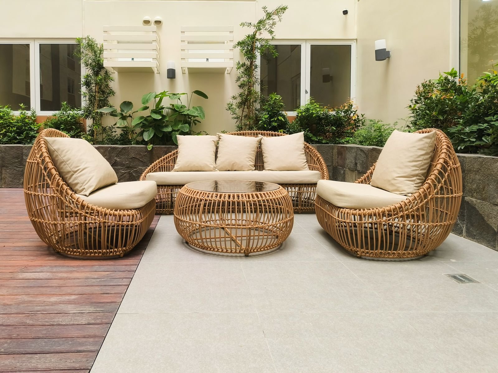 Outdoor rattan sofa and chairs arranged on a terrace
