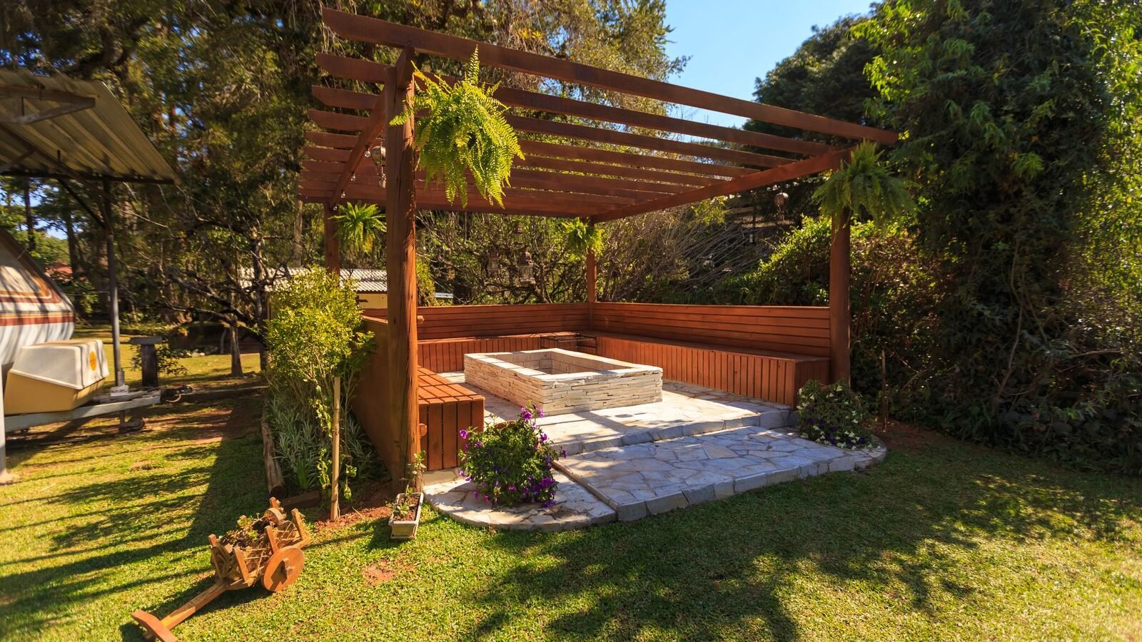 Compact wooden pergola in a leafy garden seating area