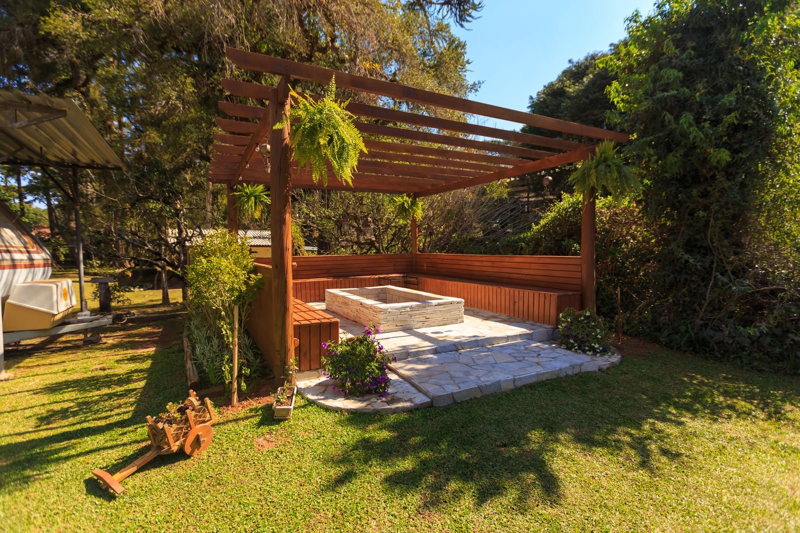 Compact wooden pergola in a leafy garden seating area