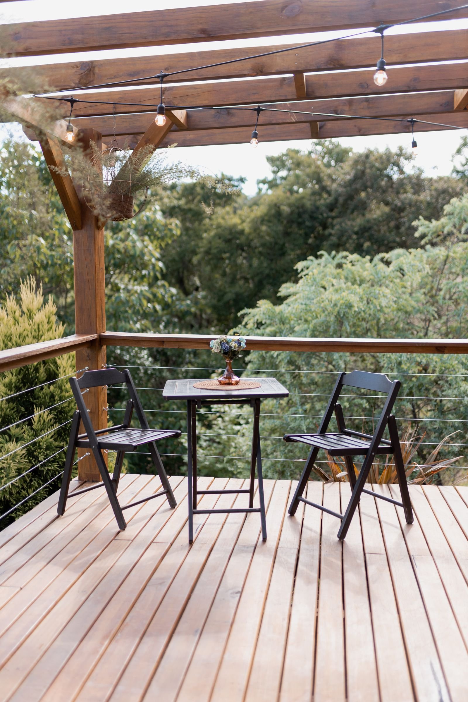 Small patio pergola with chairs and a table for outdoor use