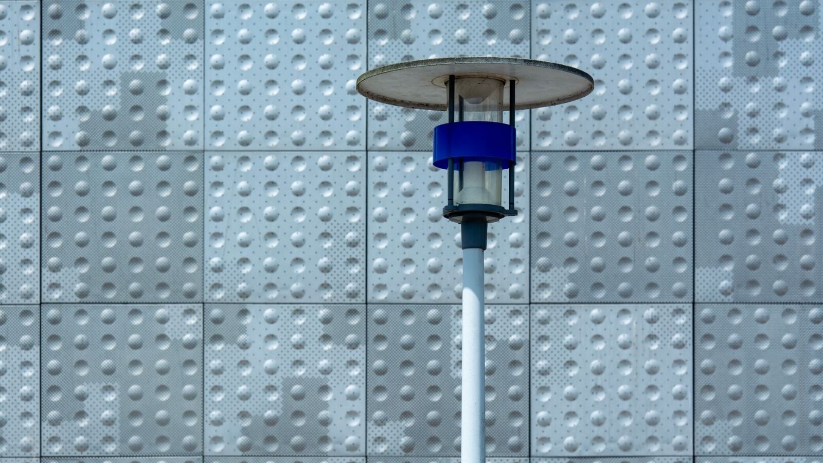 Modern solar lamp mounted against an exterior wall