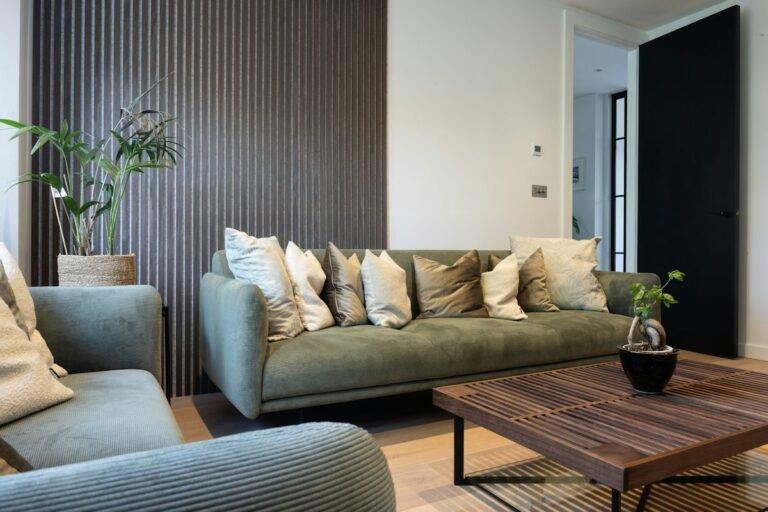 Living room with dark vertical wall panelling, neutral seating, and coffee table