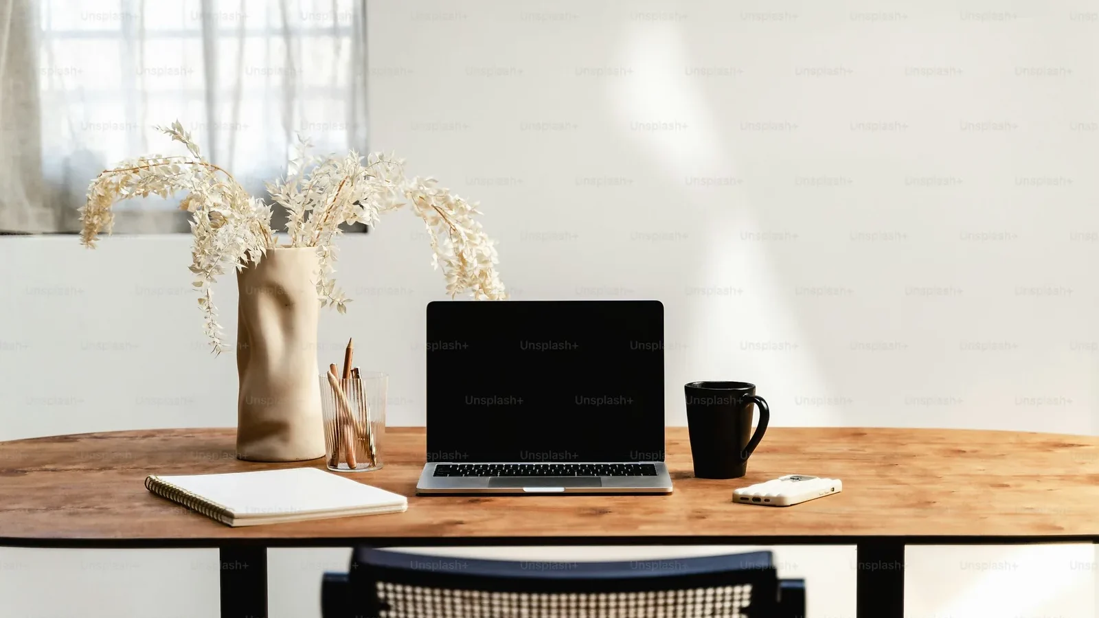 Laptop and desk arranged in a bright home living area