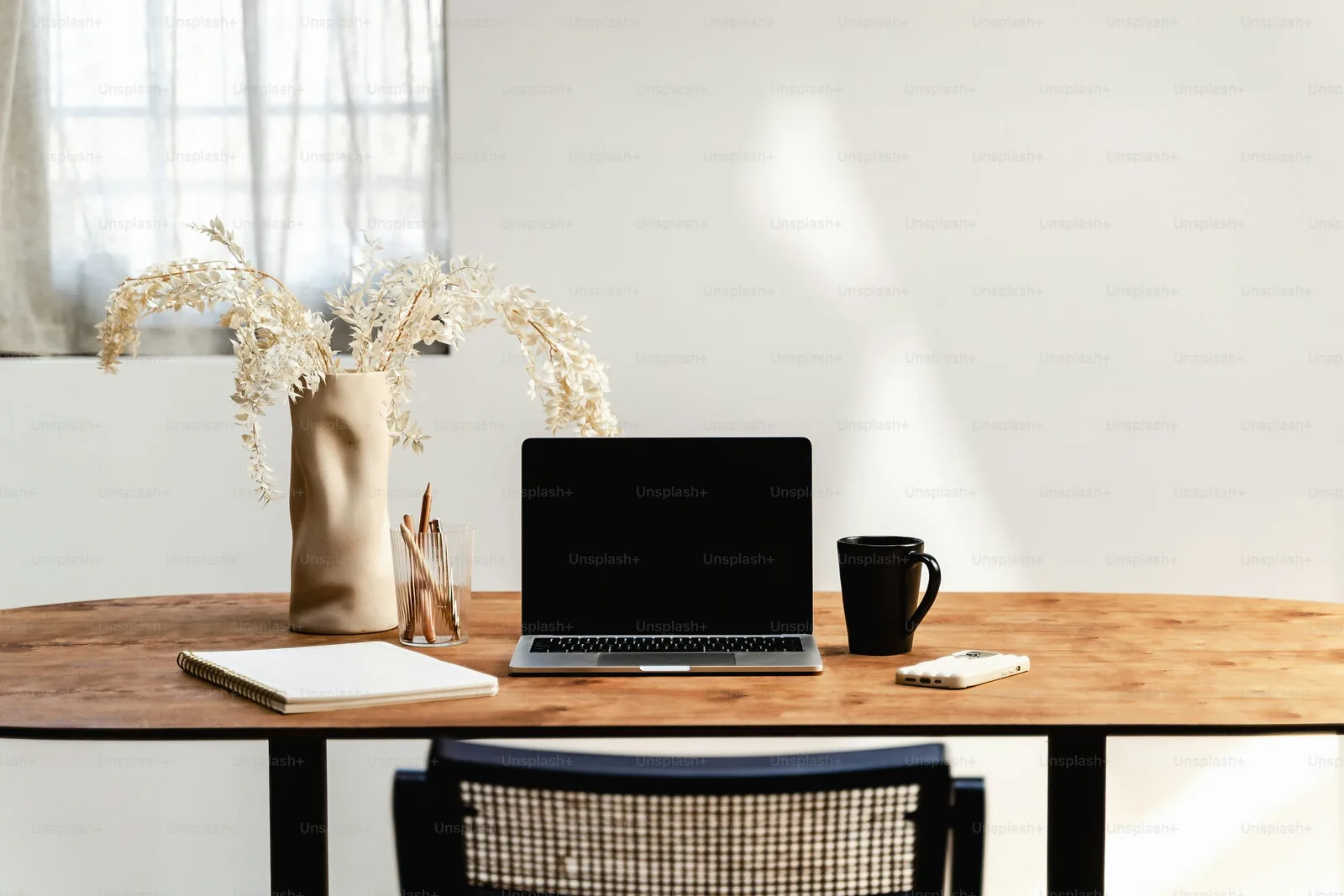 Laptop and desk arranged in a bright home living area