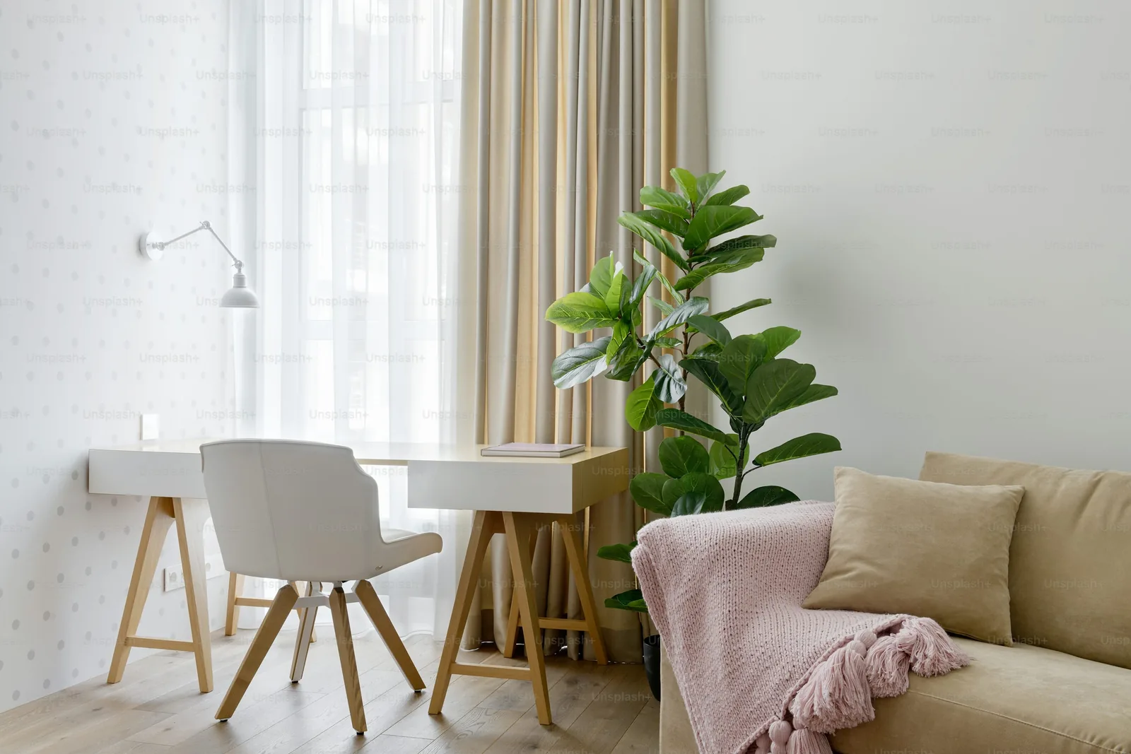 Compact desk in a bright room with a window and chair