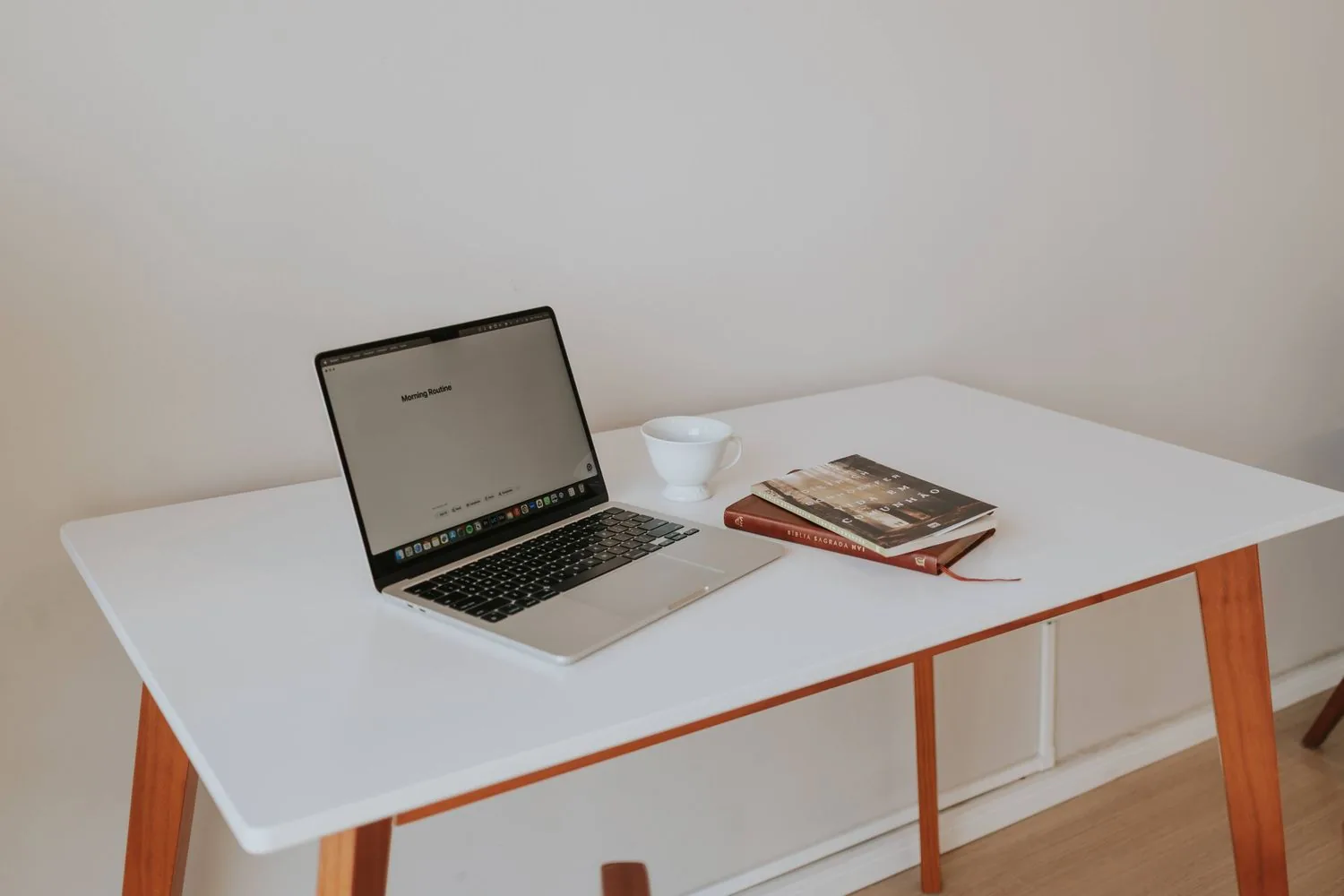 Laptop placed on a simple compact desk in a bright room