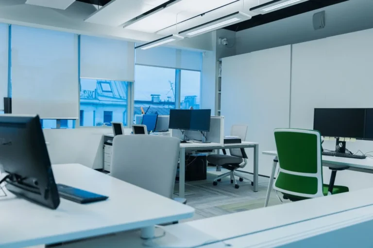 Bright modern office workstations beside large windows