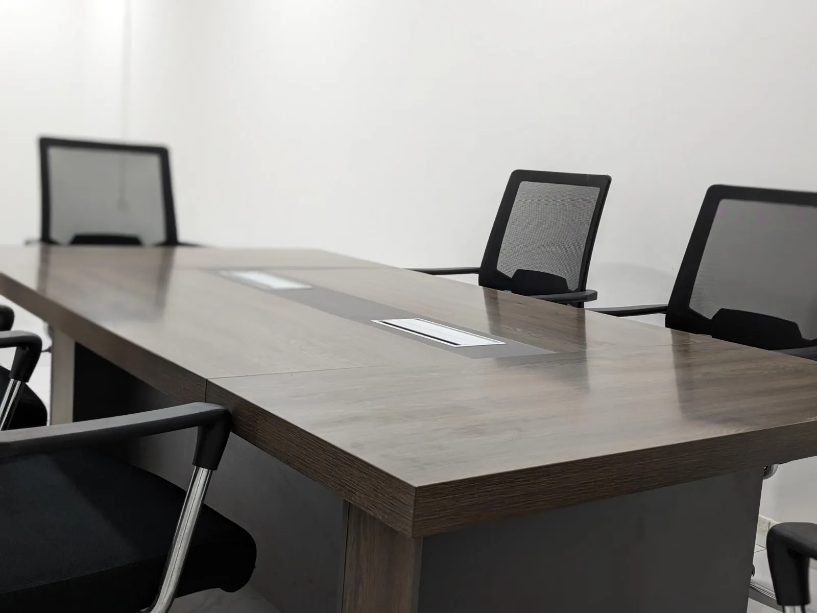Empty conference room with a long table and chairs ready for a meeting